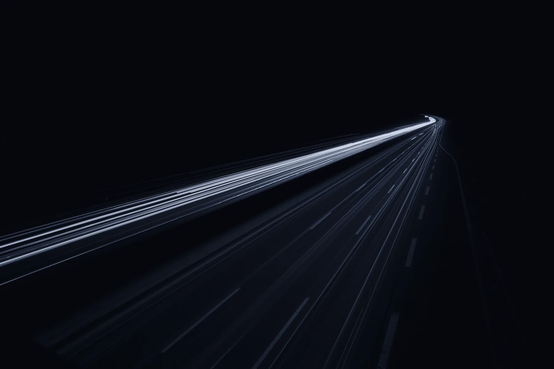 Light trails from traffic on a highway at night